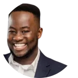 Dr Michael Anaman, a dental professional in the UK, cheerful smiling with a close-cropped haircut, wearing a suit and white shirt, against a transparent background.